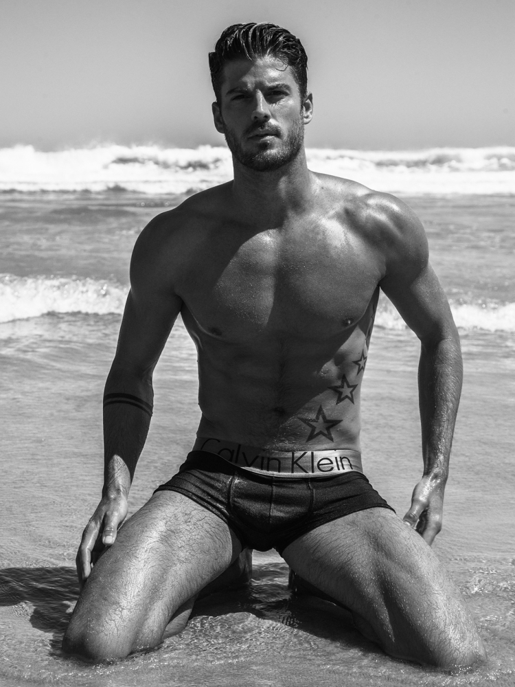 Kevin Lutolf on the beach in black and white